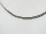 a silver necklace on a white mannequin display