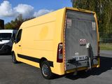 a yellow van that is parked in a parking lot