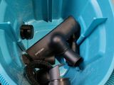 a blue bowl filled with different types of hair dryers