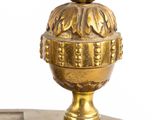 a gold clock with a bird on top of it