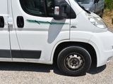 a small white van parked in a parking lot