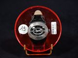 a watch in a red case with a white number on it