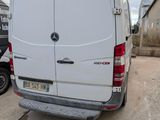 a white van that is parked on the side of the road