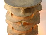 a lamp that is sitting next to a stack of rocks