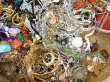 a wooden box filled with lots of jewelry on a table