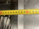 a measuring tape on the side of an oven door