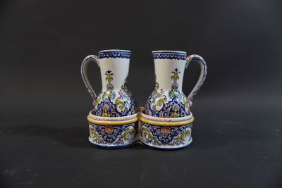 two blue and white vases sitting on top of a black table