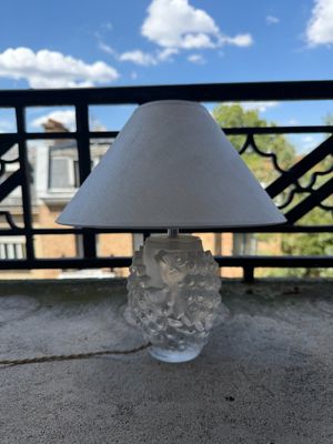 a lamp that is sitting on a table in front of a balcony