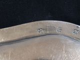 a close up of a silver spoon on a black surface