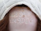 a close up of a mannequin head with a white cloth covering it