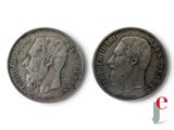 two silver coins with a man ' s head and a woman ' s face