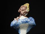 blue and white porcelain bust of a woman with a bird on her head