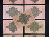 a group of five different bank notes sitting on top of each other