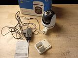 a camera that is sitting on a table next to a box