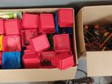 two boxes of assorted toys sitting on a table