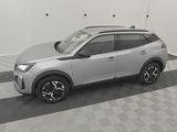 the silver suv is parked in the garage on the checkered floor