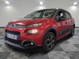 the red citrole is parked in a room with a checkered floor