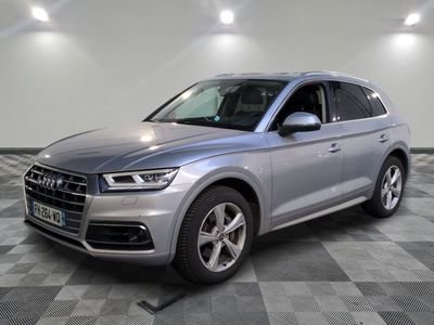 a silver audi suv parked on a checkered floor in a showroom