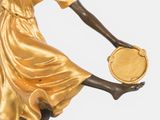 bronze statue of a woman holding a fan on a marble base