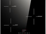 a close up of a black glass stove top with buttons on it