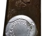 a metal tray that has a small metal object on it
