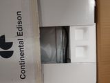 a white refrigerator in a box with a black logo on it