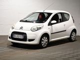 a small white car that is parked in a garage