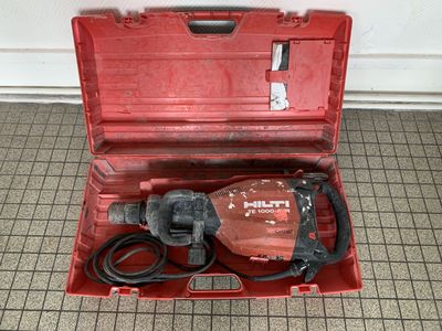 a red tool box with a hammer inside of it
