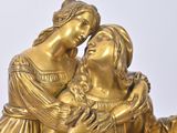 a gold statue of a woman and a child on a horse
