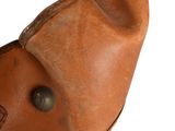 brown leather shoe with a hole in the middle of the shoe