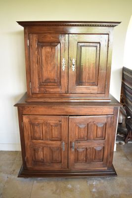 a wooden cabinet with a mirror on top of it
