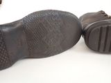 a pair of brown shoes that are on a table