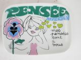 a plate with a picture of a woman holding a flower