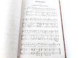 a book with music written in it on a table