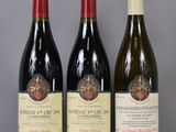 three bottles of wine are lined up on a table