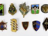 a lot of badges that are on a white surface