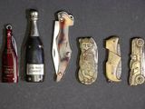 une bouteille de vin, un couteau, un décapsuleur et un ouvre-bouteille