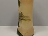 a vase that has a picture of a house on it