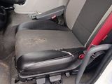 a seat in the back of a car that has a broken arm rest