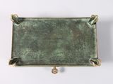a close up of a metal tray on a white surface