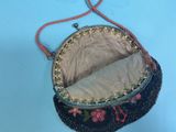 a black purse with a flower design on it