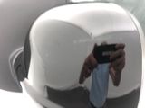 reflection of a man taking a picture of himself in a car mirror