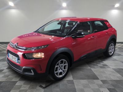 the red citrole is parked in a large room