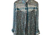 the shirt is blue and white with a pattern on it