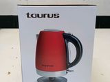 packaging of a red and black electric kettle sitting on a table