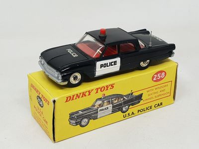 a toy police car sitting on top of a box