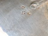 a close up of a metal object with holes in it