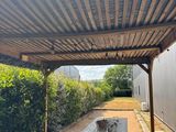 a picnic table under a covered structure in the yard