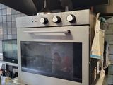 a stove that is in a kitchen with a stove top oven
