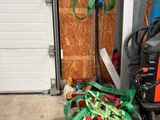 a pile of green and red hoses in front of a garage door